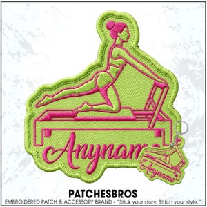 May include: A lime green embroidered patch and matching keychain featuring a pink outline of a person performing a pilates exercise on a reformer machine. The text Anyname is stitched in pink cursive script across the bottom of both items.