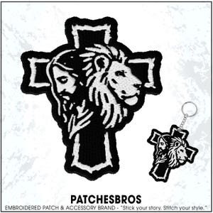 May include: Black and white embroidered patch and keychain featuring a cross design with a lion and a human face. The patch and keychain have a white border. The text "PATCHESBROS" is at the bottom.