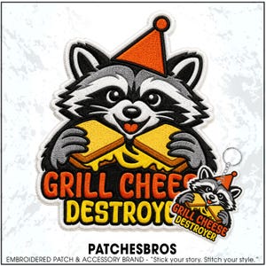 May include: An embroidered patch and a matching keychain featuring a raccoon wearing an orange party hat and holding a grilled cheese sandwich. The design includes the text "GRILL CHEESE DESTROYER" in bold orange and yellow lettering with black outlines.