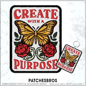 May include: Embroidered patch with a butterfly and roses design. The patch reads "CREATE WITH A PURPOSE" in red letters. A matching keychain is also visible.