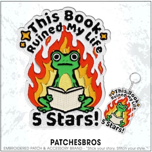 May include: Embroidered patch and keychain set featuring a green frog reading a book, surrounded by flames. The text "This Book Ruined My Life" and "5 Stars!" are included. The brand name "PATCHESBROS" is also visible.