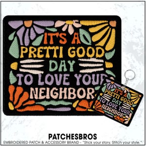 May include: Black embroidered patch and keychain set with the phrase "IT'S A PRETTI GOOD DAY TO LOVE YOUR NEIGHBOR" in colorful lettering. Floral designs in orange, yellow, and purple surround the text.