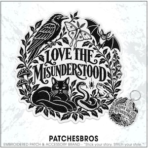 May include: A circular embroidered patch and a matching circular keychain featuring black and white illustrations of a crow, moth, bat, cat, snake, frog, spider, and mushrooms, with the text LOVE THE MISUNDERSTOOD centered in the design.