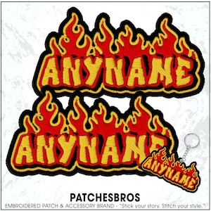 May include: Embroidered patches and a keychain with the text "ANYNAME" in yellow, outlined in black, and set against a red flame design. The patches and keychain are from the brand PATCHESBROS.