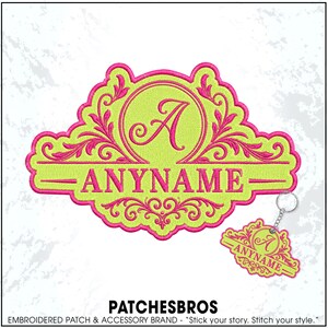 May include: A lime green embroidered patch and a matching keychain featuring a hot pink decorative border, ornate scrollwork, a central letter A, and the text ANYNAME in a bold serif font, all rendered in a vibrant two-tone color scheme.