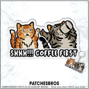May include: Embroidered patch featuring two cartoon cats with the text "SHHH!!! COFFEE FIRST." One cat is orange and white, the other is gray and white. A small keychain with the same design is also visible.