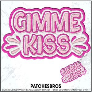 May include: Embroidered patch with the words "GIMME KISS" in pink and white, with a matching keychain. The patch has a wavy border and a candy-like design. The brand name "PATCHESBROS" is at the bottom.