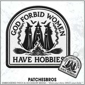 May include: A black and white embroidered patch and matching keychain featuring three figures in pointed hats and cloaks standing around a campfire with two crossed broomsticks. The text reads GOD FORBID WOMEN HAVE HOBBIES in black lettering.
