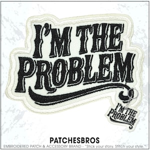 May include: Embroidered patch with the text "I'M THE PROBLEM" in black, outlined in white, and a matching keychain. The patch has a cream-colored border and a curved design. The brand name "PATCHESBROS" is at the bottom.