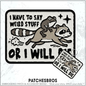 May include: Embroidered patch with the text "I HAVE TO SAY WEIRD STUFF OR I WILL" featuring a raccoon carrying a frog. A matching keychain is also visible. The patch and keychain are black, white, and tan.