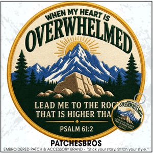 May include: A circular embroidered patch featuring a mountain landscape with a sun, pine trees, and a large rock formation. The text reads: WHEN MY HEART IS OVERWHELMED LEAD ME TO THE ROCK THAT IS HIGHER THAN I PSALM 61:2. A matching keychain is included.