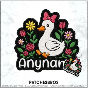 May include: An embroidered patch and matching keychain featuring a white duck with an orange beak and feet, wearing a pink bow. The design includes red roses, pink and yellow daisies, and green leaves on a black background with the text Anyname.