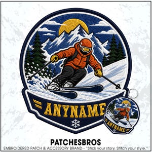 May include: A circular embroidered patch and matching keychain featuring a skier in an orange jacket and black pants skiing down a snowy mountain slope. The design includes a yellow sun, blue sky, green pine trees, and the text ANYNAME in gold.