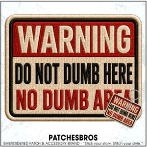 May include: A rectangular embroidered patch featuring a red top section with the word WARNING in beige, and a beige bottom section with the text DO NOT DUMB HERE NO DUMB AREA in black and red. A smaller matching keychain version is also visible.
