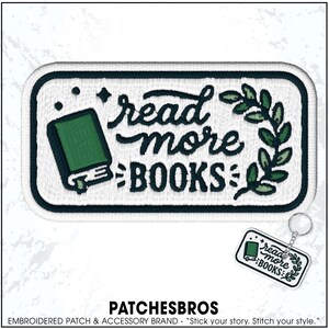 May include: Embroidered patch with the words "read more BOOKS" in a whimsical font, featuring a green book illustration and a laurel wreath design. A matching keychain is also visible. The patch has a white background with a dark green border.