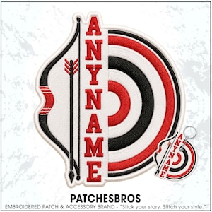 May include: An embroidered patch and matching keychain featuring a target design with concentric red, black, and white rings. A vertical black arrow is positioned to the left of the text ANYNAME, which is stitched in bold red capital letters.