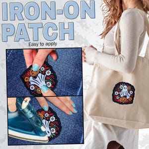 May include: An iron-on patch with a Halloween theme. The patch features a white ghost, orange pumpkin, and colorful floral elements. The text "IRON-ON PATCH" and "Easy to apply" are displayed in the image.