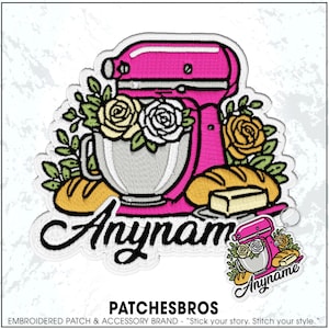 May include: An embroidered patch featuring a bright pink stand mixer, white and yellow roses, green leaves, two loaves of bread, and a stick of butter. The word Anyname is written in black cursive script across the bottom of the design.