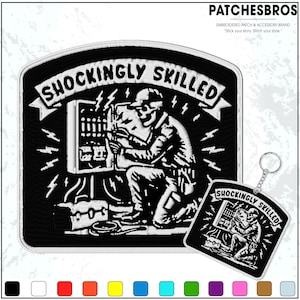 May include: Black and white embroidered patch and keychain set. The patch features a kneeling electrician working on a panel, with the text "SHOCKINGLY SKILLED". The keychain mirrors the patch design. The brand name "PATCHESBROS" is at the top.