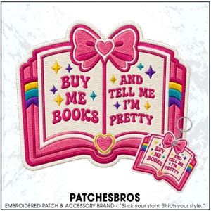 May include: An embroidered patch and a matching keychain shaped like an open book with pink borders, a pink bow, and a heart. The text reads "BUY ME BOOKS AND TELL ME I'M PRETTY" in pink letters, accented by small yellow, purple, and teal stars.