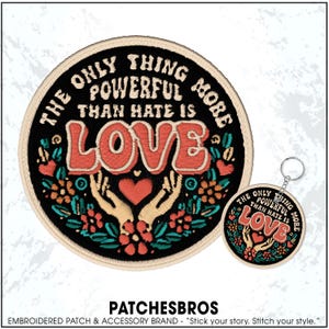 May include: Round embroidered patch and keychain with the text "THE ONLY THING MORE POWERFUL THAN HATE IS LOVE." The patch and keychain feature a heart, hands, and floral design in red, orange, and teal on a black background.