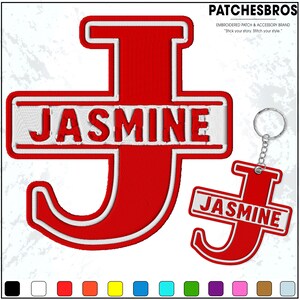 May include: Red embroidered patch and keychain set featuring the name "Jasmine" in white lettering. The patch and keychain are shaped like the letter "J". The brand name "PATCHESBROS" is at the top.