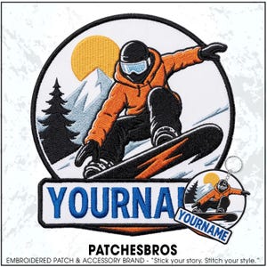 May include: A circular embroidered patch and a matching circular keychain featuring a snowboarder in an orange hoodie and black pants on a snowy mountain with a yellow sun and pine tree. The text YOURNAME is embroidered in blue on a white banner.