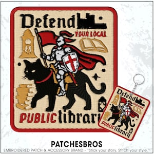 May include: Embroidered patch and keychain set with a knight riding a black cat, holding a flag, and shield. The patch reads "Defend Your Local Public Library." The design includes a red border and accents.
