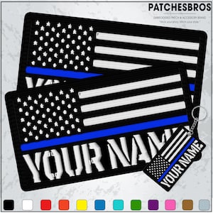 May include: Black embroidered patches and a keychain featuring a stylized American flag design with a blue stripe. The patches and keychain have the text "YOUR NAME" in white. The brand name "PATCHESBROS" is at the top.