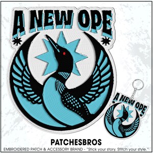 May include: Embroidered patch and keychain set featuring a stylized bird design with the text "A NEW OPE". The bird is black and turquoise, with a red eye, set against a white background. The keychain mirrors the patch design.