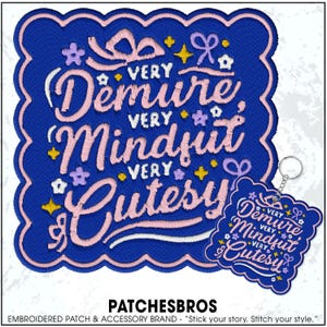 May include: A blue embroidered patch and keychain set with the words "Very Demure, Very Mindful, Very Cutesy" in pink script. The patch has a scalloped edge and is decorated with small floral and star accents.