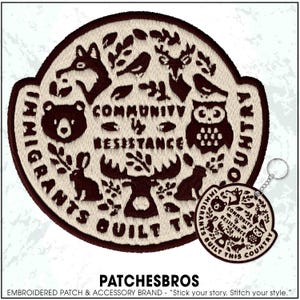 May include: Embroidered patch with a circular design featuring woodland animals and the text "Community & Resistance." A matching keychain is also visible. The patch and keychain are brown and cream-colored.