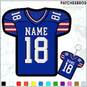 May include: A blue jersey-shaped patch and keychain with the number 18 and the word "NAME" in white. The jersey has red and white stripes on the sleeves and a white collar. The keychain is a miniature version of the patch.