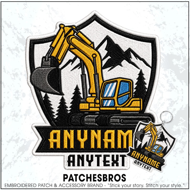 May include: An embroidered patch and matching keychain featuring a yellow excavator on a black and white shield background with mountains and pine trees. The design includes a black banner with the yellow text ANYNAME and the white text ANYTEXT.