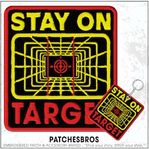 May include: Embroidered patch and keychain set with the words "STAY ON TARGET". The patch features a yellow and black geometric design with a red target in the center. The keychain has the same design. The patch and keychain are bordered in red.