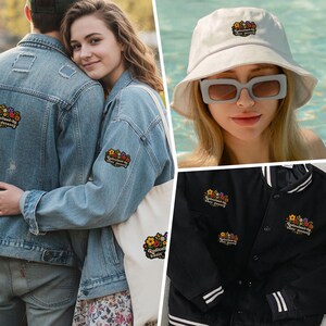 May include: A collection of apparel and accessories featuring an embroidered floral patch with the text Radicalized by basic decency. Items include a light blue denim jacket, a white bucket hat, a canvas tote bag, and a black varsity jacket.
