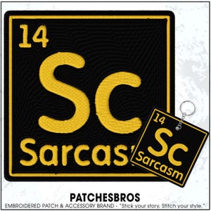 May include: Black and yellow embroidered patch and keychain set. The patch and keychain feature the periodic table symbol "Sc" for Sarcasm, with the number 14. The text "Sarcasm" is below the symbol.