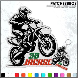 May include: Embroidered patch featuring a black and white motocross rider on a motorcycle, with the number "36" and the name "Jackson" in green and orange. Includes a keychain with a similar design.