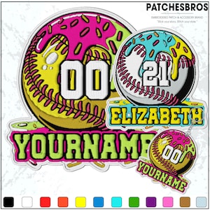 May include: Embroidered patches with a softball theme. One patch features a pink and yellow donut design with the number "00". Another patch has a baseball design with the name "ELIZABETH" and the number "21". A smaller keychain patch repeats the donut design and number "00". The text "YOURNAME" is also present.