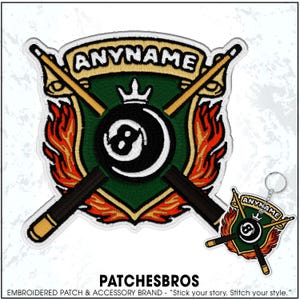 May include: Embroidered patch featuring a green shield with a black eight ball, crossed pool cues, and flames. The text "ANYNAME" is at the top. A matching keychain is also shown. The brand name "PATCHESBROS" is at the bottom.