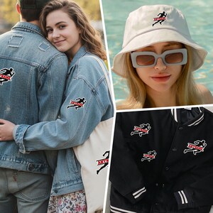 May include: A collection of apparel and accessories featuring a black silhouette of a runner with the red text ANYNAME. Items include a light blue denim jacket, a white bucket hat, a black varsity jacket, and a white canvas tote bag.