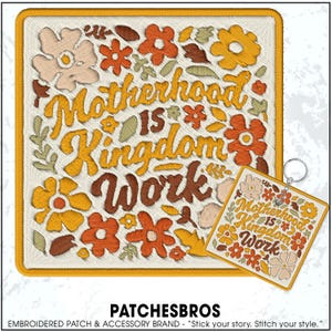 May include: Embroidered patch with the text "Motherhood is Kingdom Work" in a retro font, surrounded by floral designs in shades of orange, yellow, and brown. A matching keychain is also visible. The patch has a square shape with a yellow border.