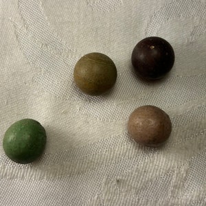 Four antique handmade clay marbles