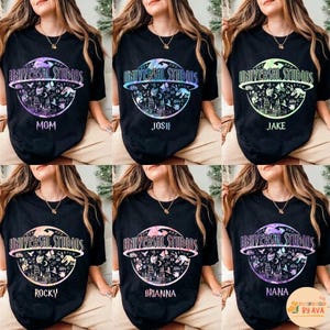 May include: Black t-shirts with the "Universal Studios" logo in a circular design. Each shirt has a different name below the logo: Mom, Josh, Jake, Rocky, Brianna, and Nana. The logo is in a rainbow color.