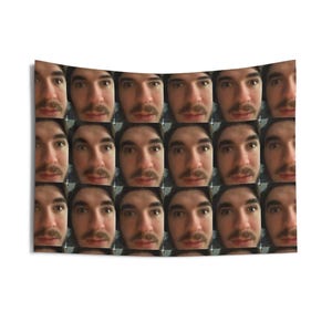 May include: A rectangular tapestry featuring a grid of twenty-one identical images of a person's face. The person has brown hair and a mustache. The background is white.