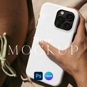 May include: A white phone case with a black camera module is held by a person. The phone case has the text "Phone MOCKUP" in a light colour. The image also includes the logos for "Ps" and "Canva".