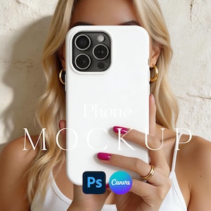 May include: A white phone case with a triple-lens camera is held up in front of a person. The words "Phone MOCKUP" are printed on the case. The person is wearing gold hoop earrings and a gold ring. The case has the Photoshop and Canva logos.