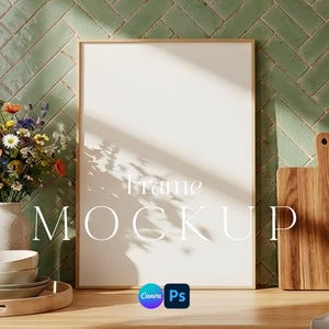 May include: A wooden-framed blank frame mockup with the text "Frame Mockup" in a bright room setting. A bouquet of flowers in a white vase, a wooden cutting board, and a stack of bowls are also present.