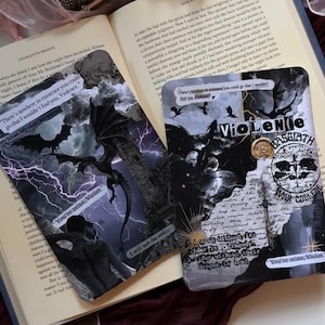 May include: Two rectangular bookmarks featuring dark fantasy collages with dragon silhouettes, lightning, and text overlays including "Violence," "Basgiath War College," and "You're mine, Violet." The designs incorporate black, white, and purple tones.