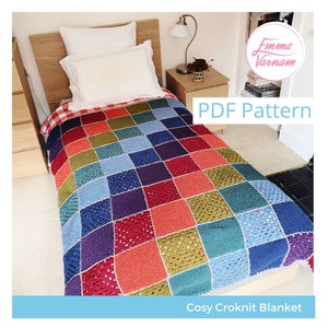 May include: A colorful crocheted blanket with a patchwork design in shades of red, blue, green, and purple. The blanket is on a bed with a white pillow and a red and white checkered bedspread. The text "PDF Pattern" and "Cosy Croknit Blanket" are visible in the image.